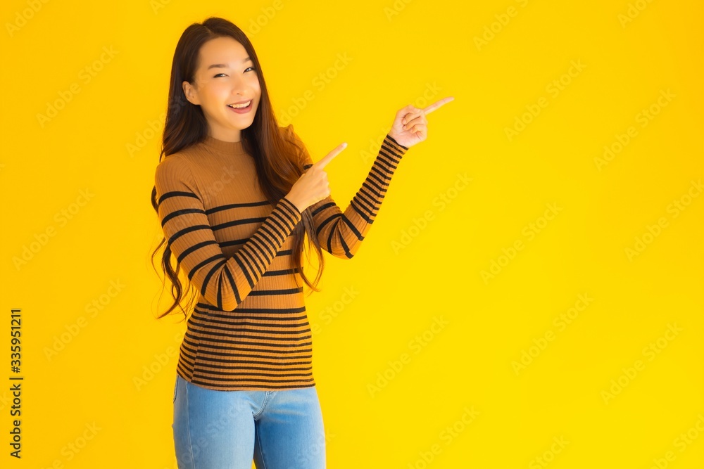 Obraz premium Portrait beautiful young asian adult woman smile with many action on yellow background