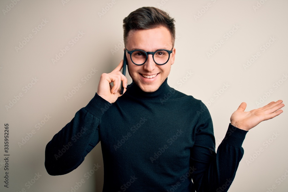 Young handsome caucasian man having a conversation talking on smartphone very happy and excited, winner expression celebrating victory screaming with big smile and raised hands Young handsome caucasian man having a conversation talking on smartphone very happy and excited, winner expression celebrating victory screaming with big smile and raised hands