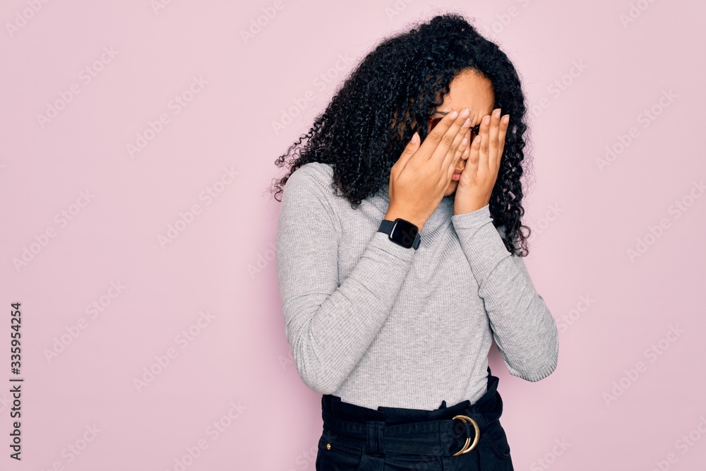Young african american woman wearing turtleneck sweater and glasses over pink background rubbing eyes for fatigue and headache, sleepy and tired expression. Vision problem Young african american woman wearing turtleneck sweater and glasses over pink background rubbing eyes for fatigue and headache, sleepy and tired expression. Vision problem