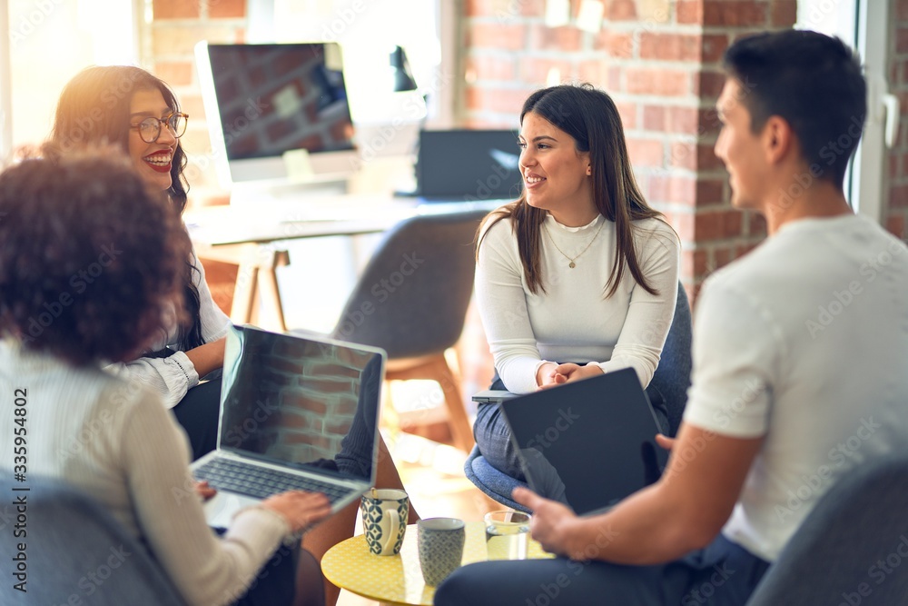Group of business workers smiling happy and confident. Sitting on chairs relaxed with smile on face. Speaking taking rest at the office Group of business workers smiling happy and confident. Sitting on chairs relaxed with smile on face. Speaking taking rest at the office