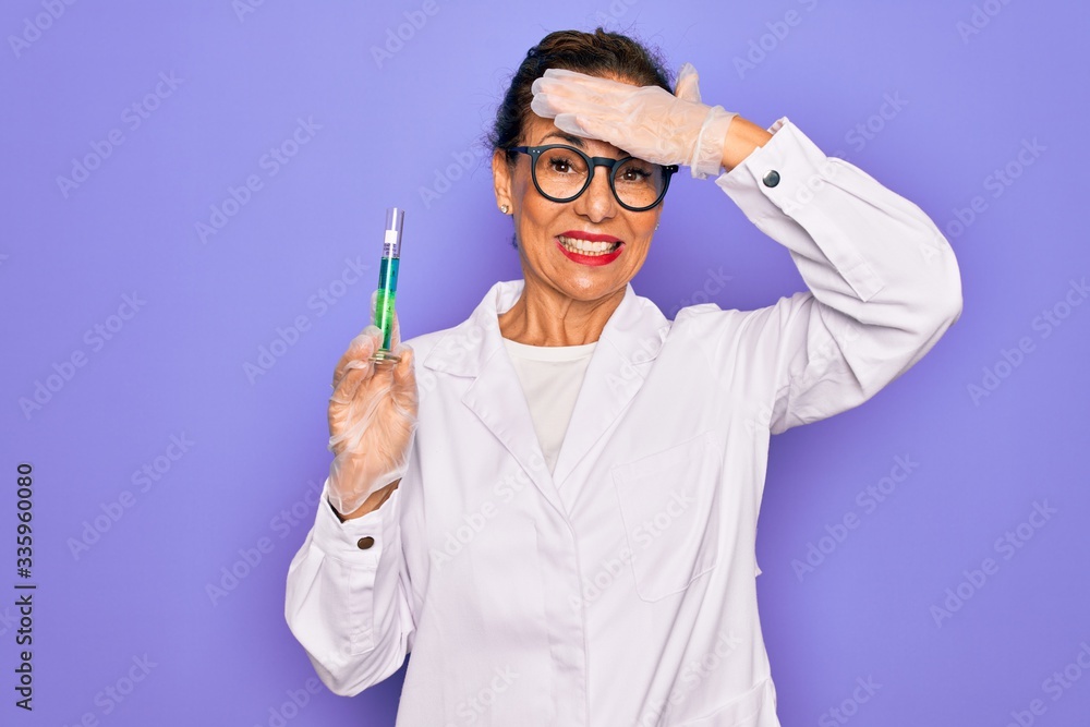 Middle age senior scientist woman wearing laboratory coat holding research test tube stressed with hand on head, shocked with shame and surprise face, angry and frustrated. Fear and upset for mistake. Middle age senior scientist woman wearing laboratory coat holding research test tube stressed with hand on head, shocked with shame and surprise face, angry and frustrated. Fear and upset for mistake.