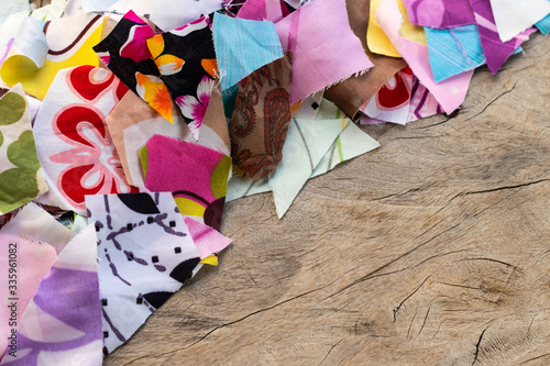 Scrap pieces of colorful fabric on the old wooden floor.