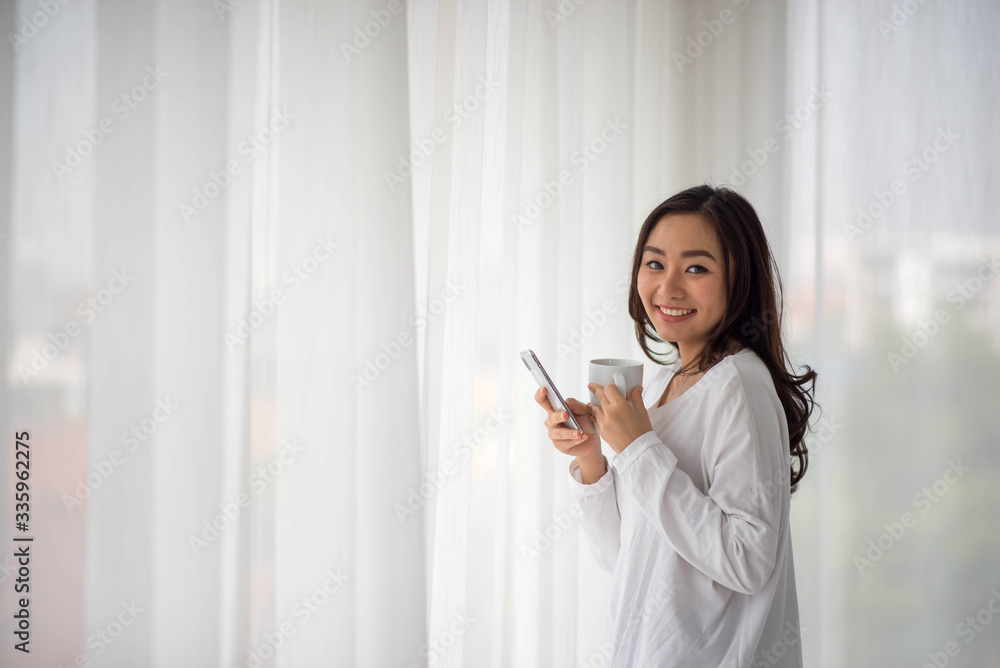 Asian woman work from home drink coffe in the morning rest time Asian woman work from home drink coffe in the morning rest time