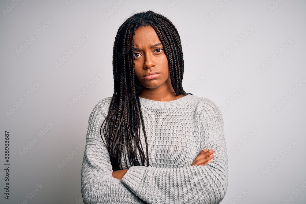Young african american woman standing casual and cool over grey isolated background skeptic and nervous, disapproving expression on face with crossed arms. Negative person. Young african american woman standing casual and cool over grey isolated background skeptic and nervous, disapproving expression on face with crossed arms. Negative person.