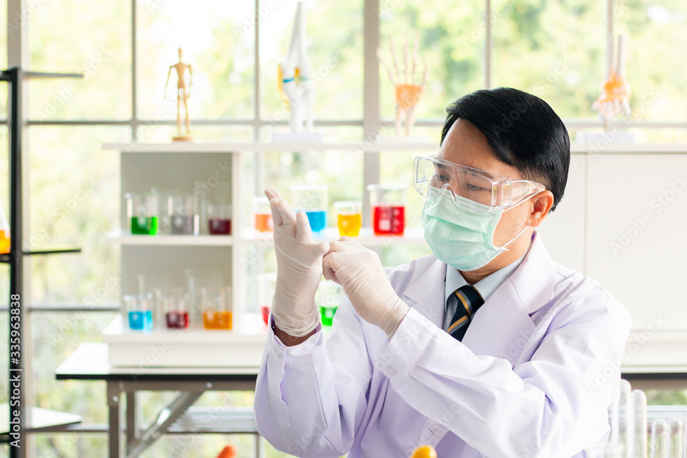 Scientists are wearing gloves to work in a lab. Scientists are wearing gloves to work in a lab.