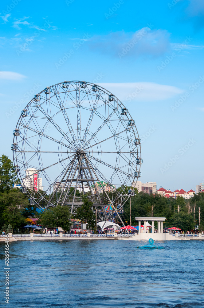 Russia, Khabarovsk, August 2019: Ferris Wheel on the Bank of the Amur river in the city of Khabarovsk in the summer