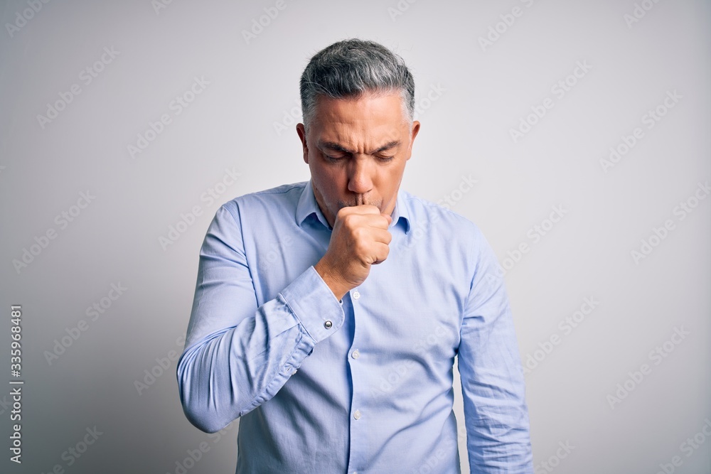 Middle age handsome grey-haired business man wearing elegant shirt over white background feeling unwell and coughing as symptom for cold or bronchitis. Health care concept. Middle age handsome grey-haired business man wearing elegant shirt over white background feeling unwell and coughing as symptom for cold or bronchitis. Health care concept.