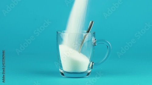 Pour sugar mug glass spoon thick bottom blue contrasting background concept