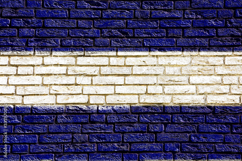 Fototapeta premium Kolorowe tło i tekstury przedstawiające flagę kraju na ścianie z cegły.