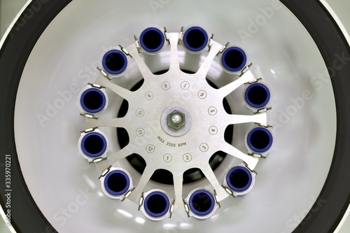 Laboratory open centrifuge with empty test tube compartments. View from above. photo