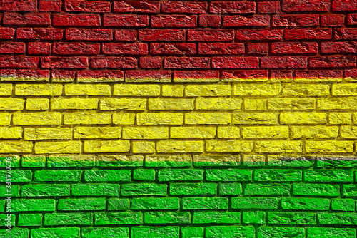 Colorful background and texture depiction of country flag on a brick wall. © Jim