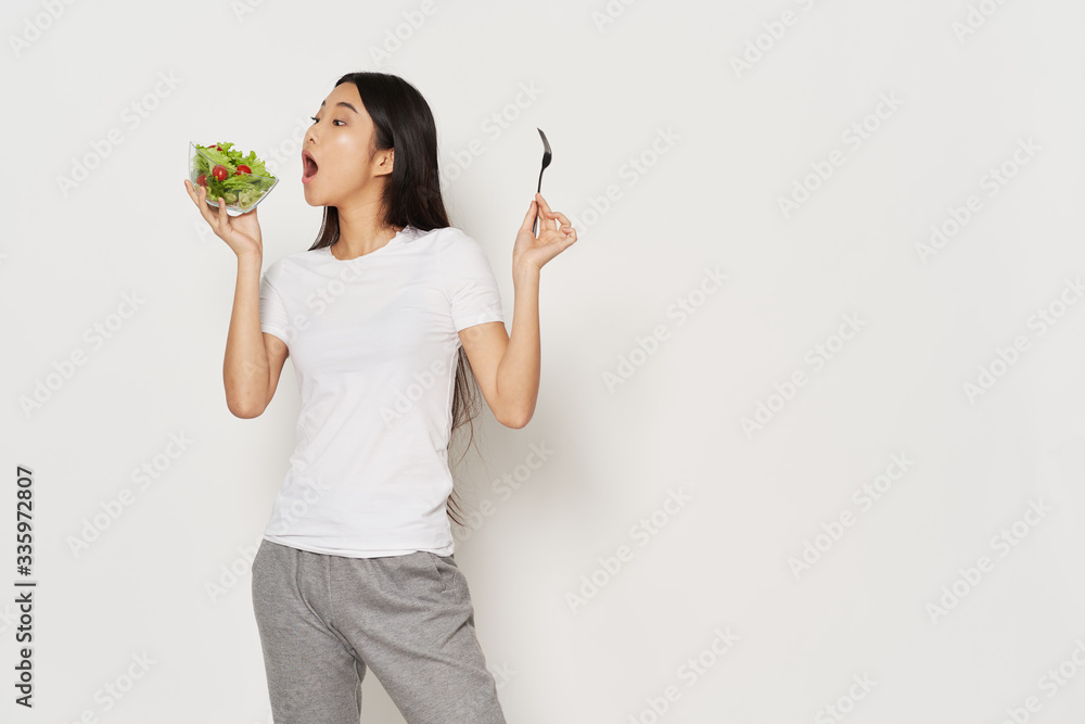 young woman holding a bowl of fresh vegetables young woman holding a bowl of fresh vegetables