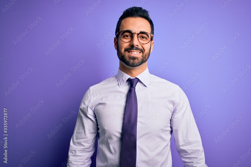 Handsome businessman with beard wearing casual tie and glasses over purple background with a happy and cool smile on face. Lucky person. Handsome businessman with beard wearing casual tie and glasses over purple background with a happy and cool smile on face. Lucky person.