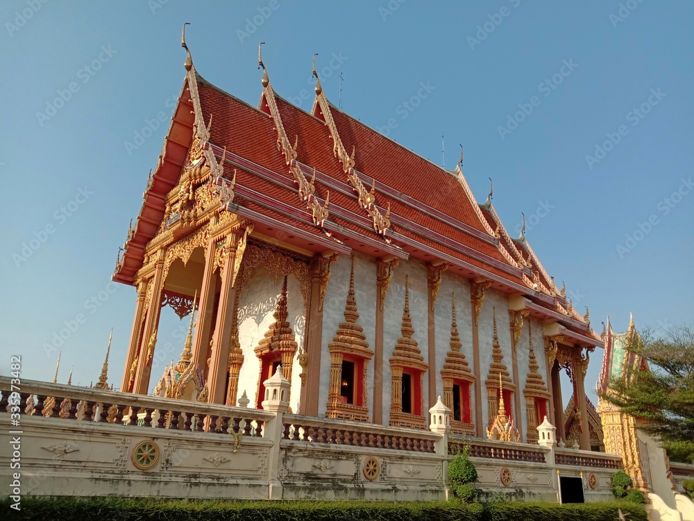 Church of Buddhist temple isolated on blue sky background closeup. Is a place religious ceremonies for Thailand people culture.