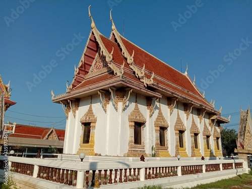 Church of Buddhist temple isolated on blue sky background closeup. Is a place religious ceremonies for Thailand people culture.