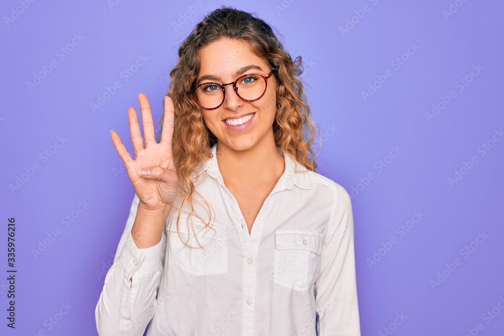 Young beautiful woman with blue eyes wearing casual shirt and glasses over purple background showing and pointing up with fingers number four while smiling confident and happy. Young beautiful woman with blue eyes wearing casual shirt and glasses over purple background showing and pointing up with fingers number four while smiling confident and happy.