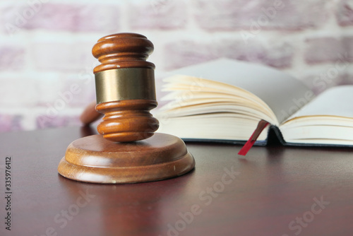 Close up of gavel and open book on table 