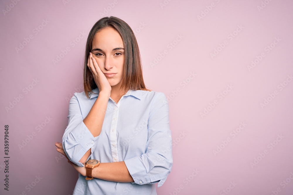 Young beautiful businesswoman wearing elegant shirt standing over isolated pink background thinking looking tired and bored with depression problems with crossed arms. Young beautiful businesswoman wearing elegant shirt standing over isolated pink background thinking looking tired and bored with depression problems with crossed arms.