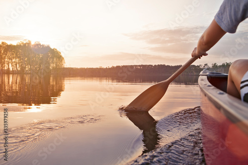Woman canoeing at sunset