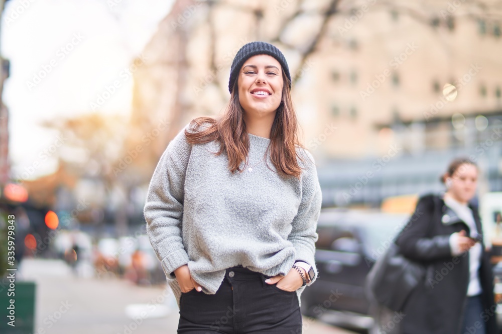 Young beautiful woman smiling happy and confident. Standing with smile on face walking at the city Young beautiful woman smiling happy and confident. Standing with smile on face walking at the city