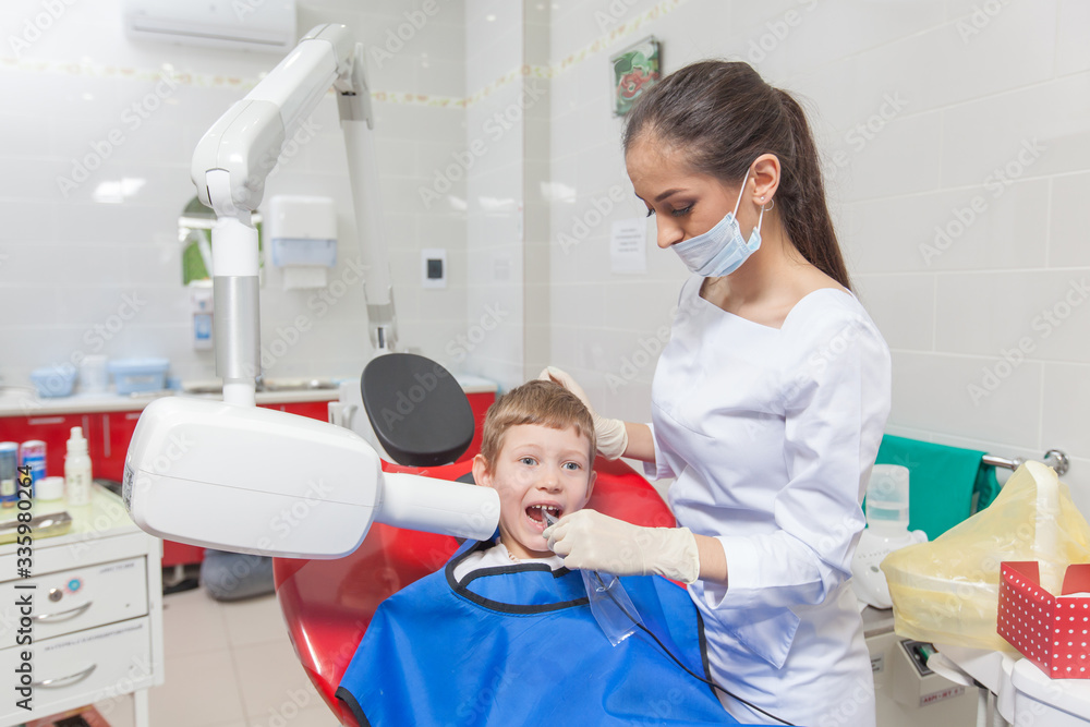 Dentist x-ray. A child with a dentist in a dental office. Dentist x-ray. A child with a dentist in a dental office.