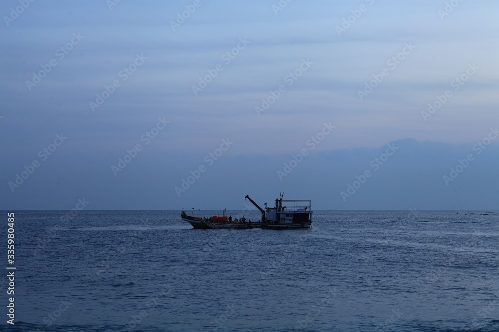 Long exposure sunrise seascape with Chinese fishing junks in the background