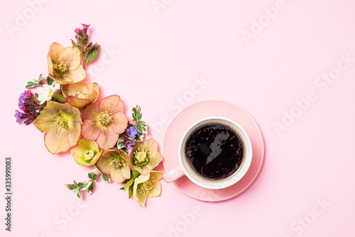 cup of coffee and flowers on the pink background