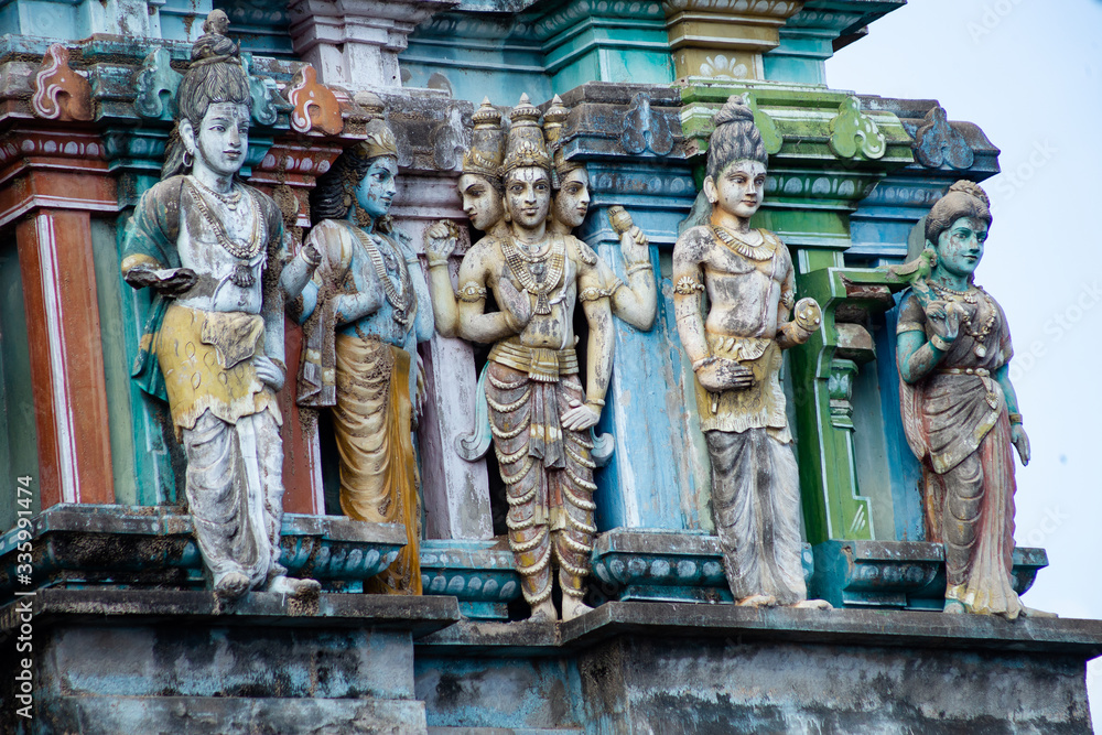 Hindu temple in Tamil Nadu, South India. Sculptures on Hindu temple gopura (tower), sculpture of an Indian deity Hindu temple in Tamil Nadu, South India. Sculptures on Hindu temple gopura (tower), sculpture of an Indian deity