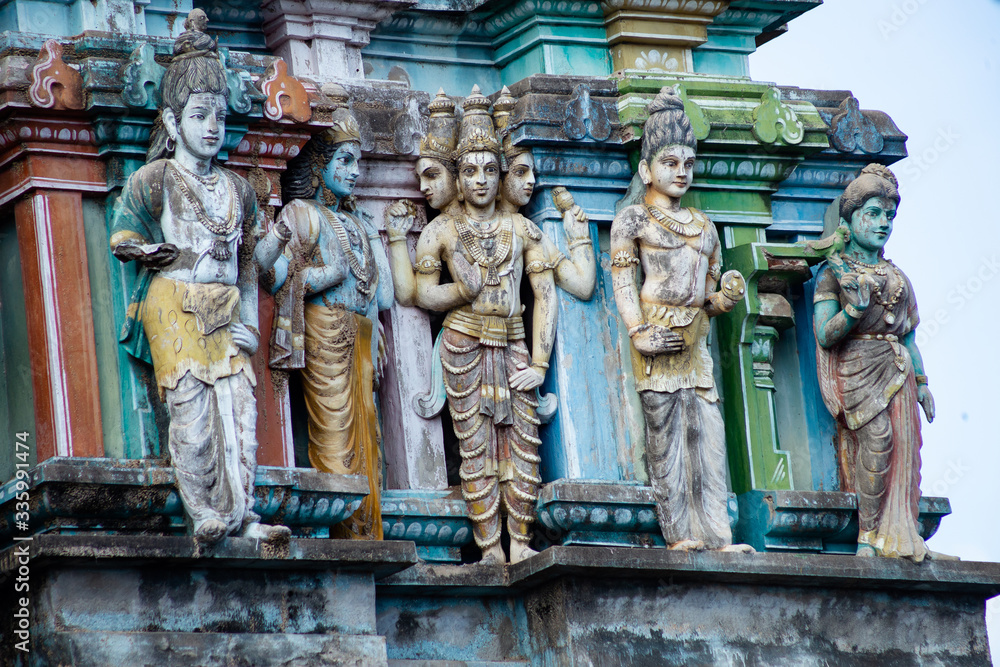 Hindu temple in Tamil Nadu, South India.  Sculptures on Hindu temple gopura (tower), sculpture of an Indian deity