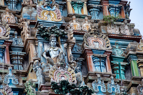Hindu temple in Tamil Nadu, South India.  Sculptures on Hindu temple gopura (tower), sculpture of an Indian deity © MaxМ