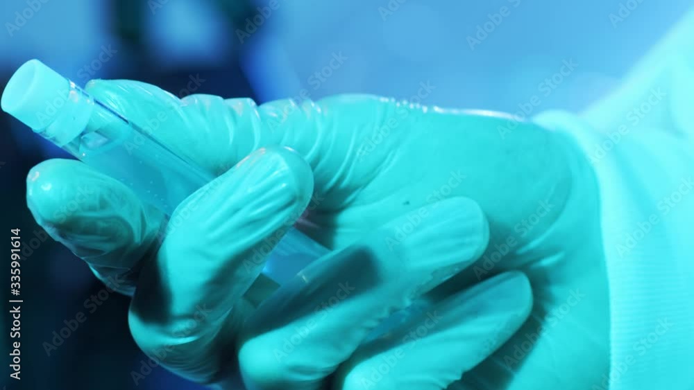 Blood and virus in the laboratory tube. Close-up of scientific lab in clinics. Pandemic disease, healthcare, vaccine research and coronavirus covid-19 test.