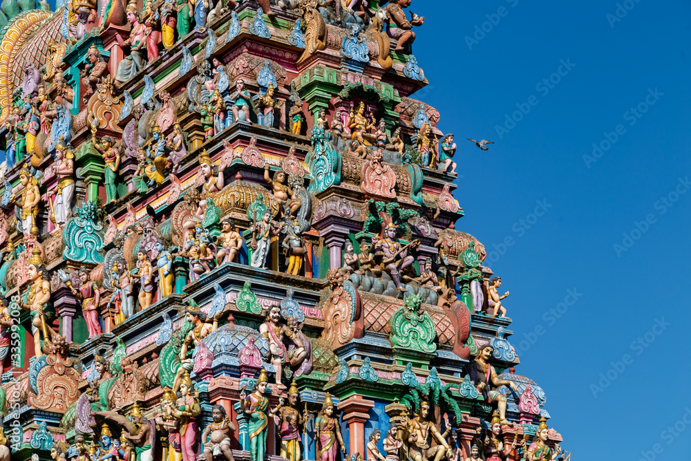 Fototapeta premium Hindu temple in Tamil Nadu, South India. Sculptures on Hindu temple gopura (tower), sculpture of an Indian deity