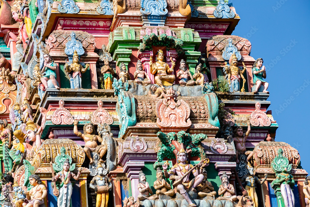 Hindu temple in Tamil Nadu, South India. Sculptures on Hindu temple gopura (tower), sculpture of an Indian deity Hindu temple in Tamil Nadu, South India. Sculptures on Hindu temple gopura (tower), sculpture of an Indian deity