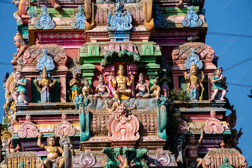 Hindu temple in Tamil Nadu, South India. Sculptures on Hindu temple gopura (tower), sculpture of an Indian deity Hindu temple in Tamil Nadu, South India. Sculptures on Hindu temple gopura (tower), sculpture of an Indian deity