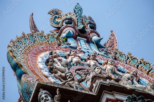 Hindu temple in Tamil Nadu, South India.  Sculptures on Hindu temple gopura (tower)
 photo