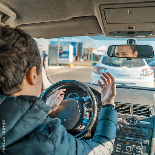 a man uses a horn in a car upset from a traffic jam in the city photo