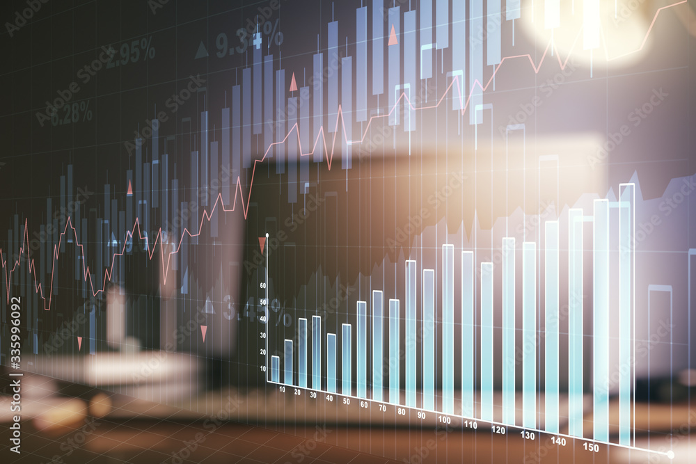 Multi exposure of abstract financial graph on laptop background, financial and trading concept Multi exposure of abstract financial graph on laptop background, financial and trading concept