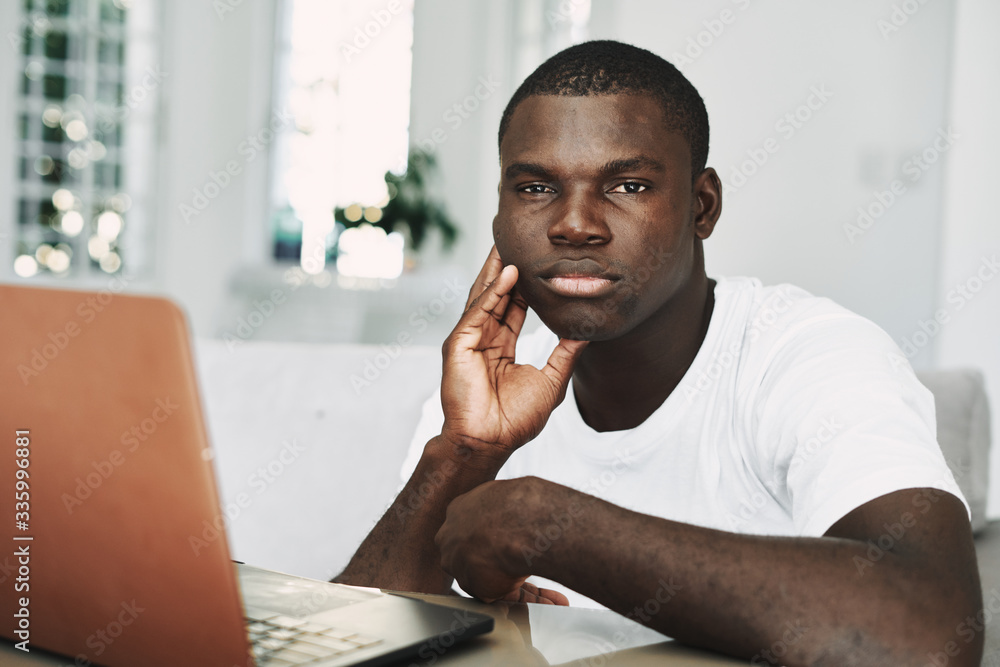 A man at home in front of a laptop A man at home in front of a laptop