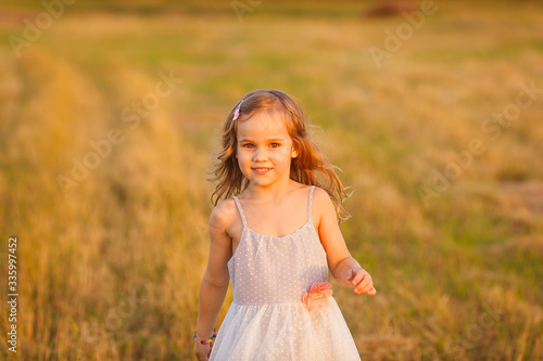 small kid girl grey dress run on wheat field