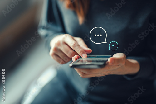 Women's hand typing on mobile smartphone, Live Chat Chatting on application Communication Digital Web and social network Concept. Work from home. photo