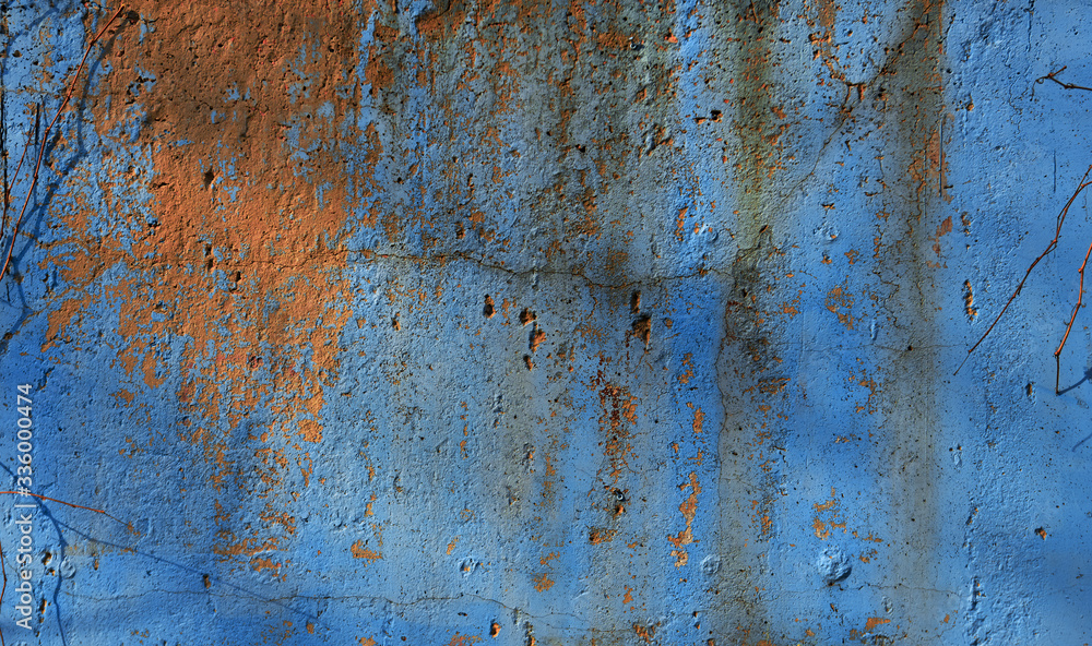 painted stucco wall with fantastic cracks and peeling paint