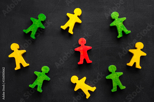 Tolerance, social protection, anti-discrimination concept. Wooden human figures on black table, top view