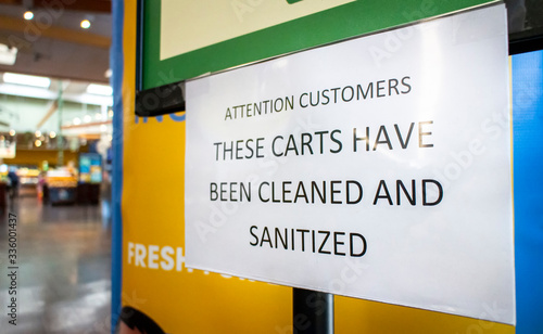 Sign at store stating Carts Have Been Cleaned And Santitized photo