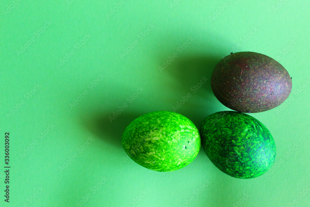 Three colored eggs on a green background. Three colored eggs on a green background.