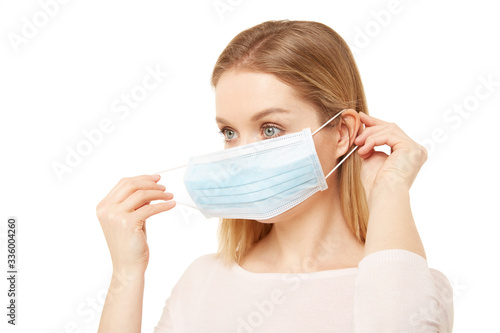 Blond woman put on a medical mask