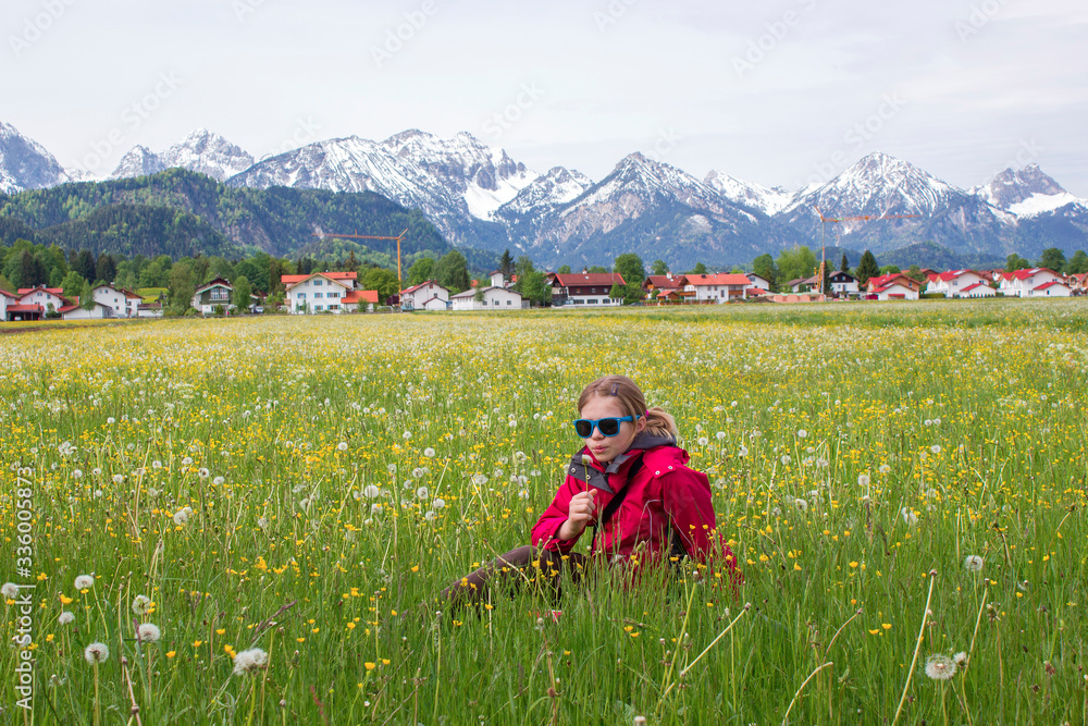 portrait of a girl against the panorama of the Alps
