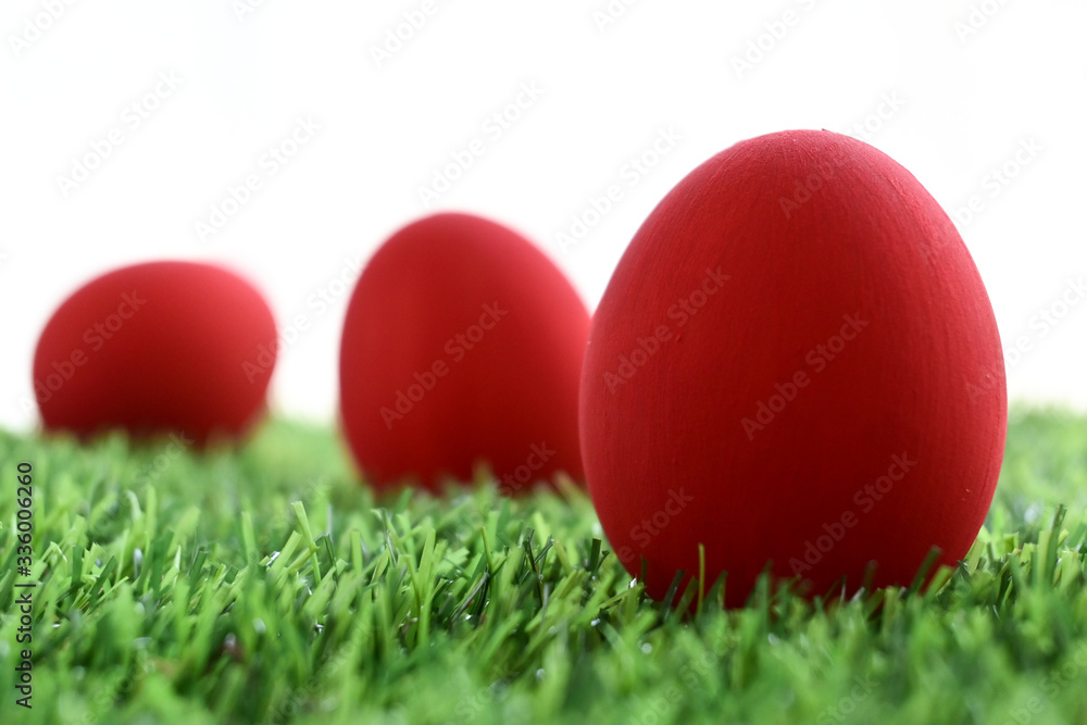 red easter egg on lawn green grass artificial with blank white background red easter egg on lawn green grass artificial with blank white background