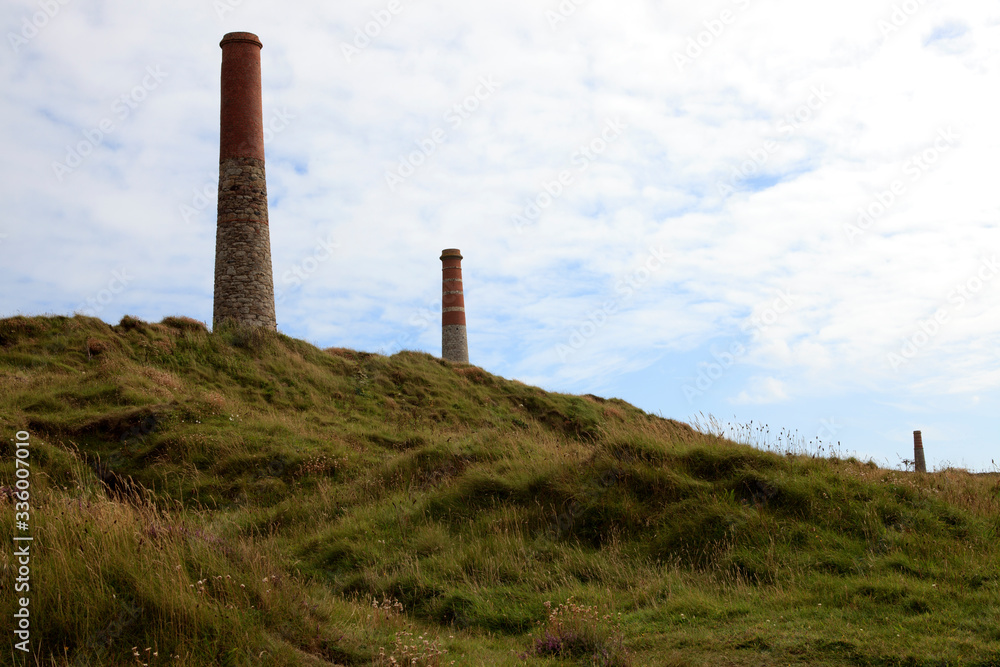 Botallack (England), UK - August 16, 2015: Chimney stack ruined mineshaft Botallack tin mine, Cornwall, England, United Kingdom.