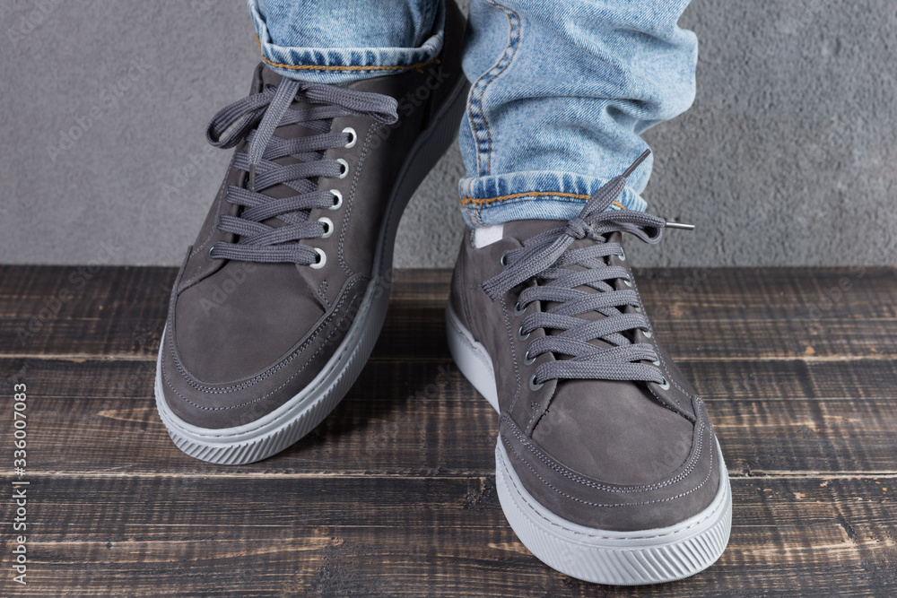 male legs with gray nubuck leather shoes, concept, as if walking male legs with gray nubuck leather shoes, concept, as if walking