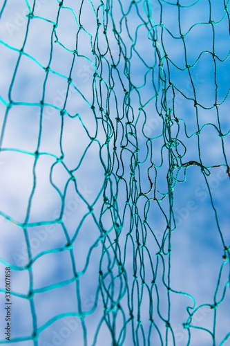 large net of threads against the sky